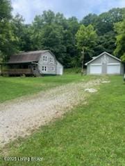 7900 Organ Creek Rd, Pendleton, KY 40055 - view of grassy yard with a detached garage, an outbuilding, and a view of trees