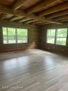 7900 Organ Creek Rd, Pendleton, KY 40055 - empty room with plenty of natural light, a wooden ceiling with exposed beams, and wood finished floors