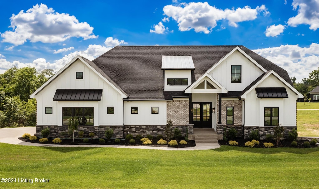 modern farmhouse style home with a front yard and french doors