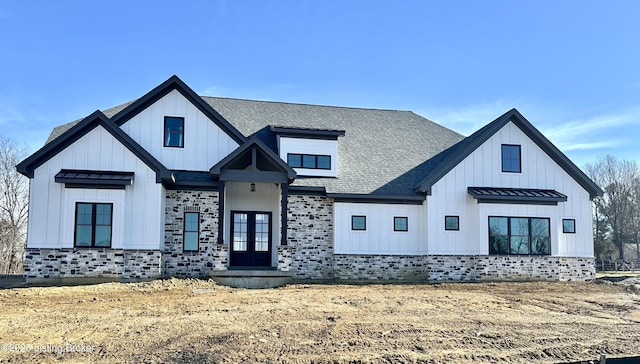 modern farmhouse style home with french doors, roof with shingles, board and batten siding, a standing seam roof, and metal roof