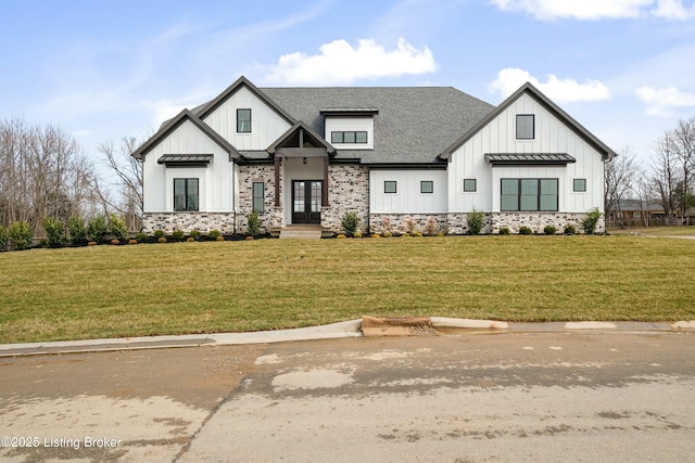 modern farmhouse featuring a standing seam roof, board and batten siding, a front lawn, and french doors