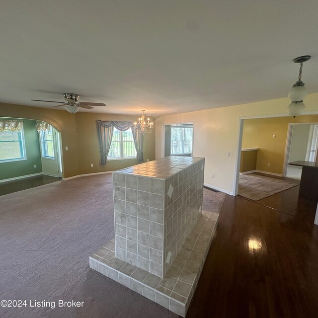 27 Jenkins Rd, Rineyville, KY 40162 - kitchen with decorative light fixtures, ceiling fan with notable chandelier, baseboards, dark wood-type flooring, and tile countertops