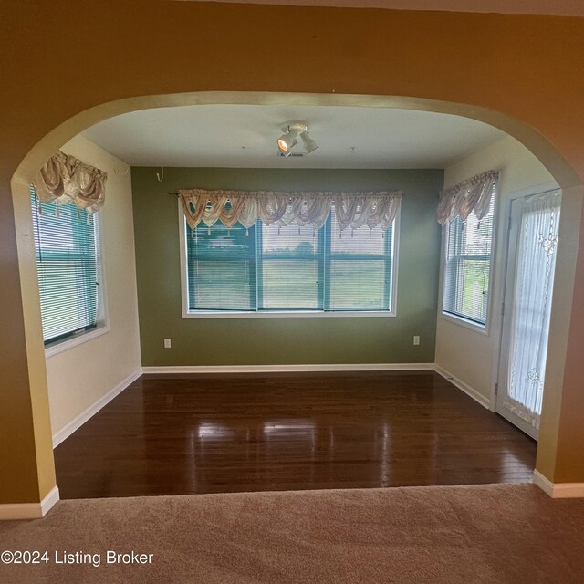 27 Jenkins Rd, Rineyville, KY 40162 - empty room featuring arched walkways, baseboards, and wood finished floors