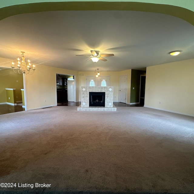 27 Jenkins Rd, Rineyville, KY 40162 - unfurnished living room with baseboards, carpet flooring, a fireplace, and ceiling fan with notable chandelier