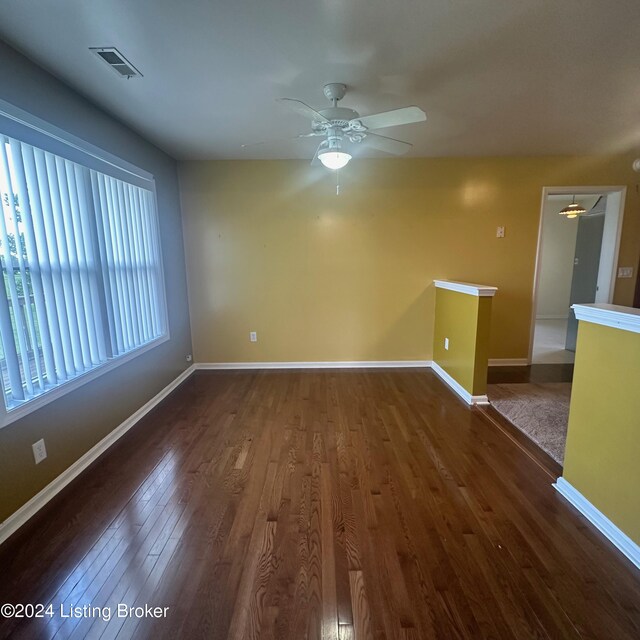 spare room featuring ceiling fan and dark wood-type flooring