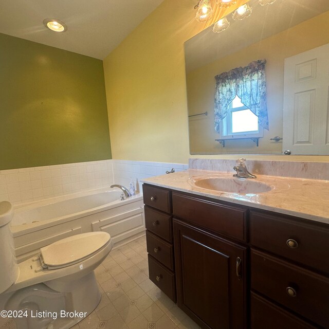 bathroom featuring tile patterned floors, a washtub, vanity, and toilet