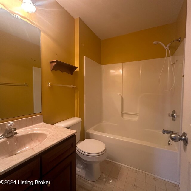 full bathroom featuring tile patterned flooring, tub / shower combination, toilet, and vanity