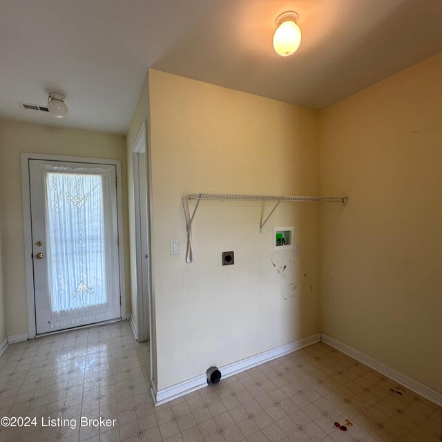 washroom featuring light tile patterned flooring, washer hookup, and hookup for an electric dryer