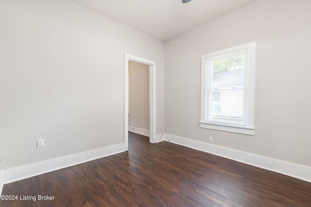 empty room featuring ceiling fan and dark hardwood / wood-style floors