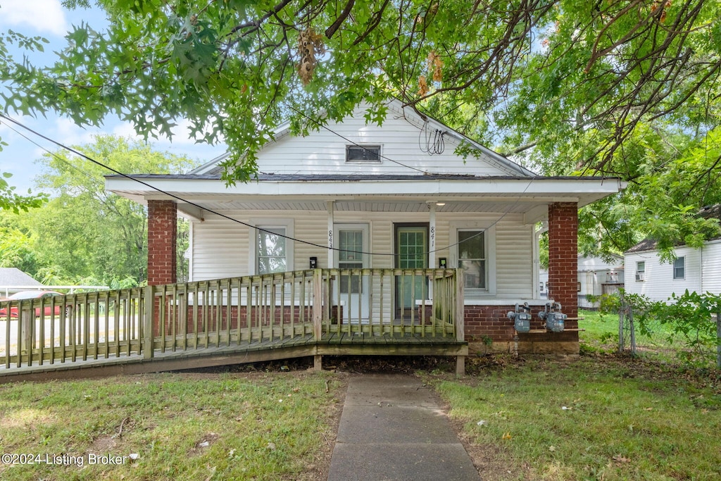 bungalow-style house featuring a porch and a front lawn