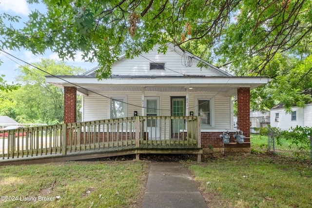 bungalow-style house featuring a porch and a front lawn