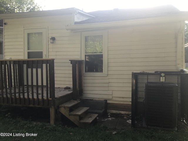 exterior space featuring central air condition unit and a wooden deck