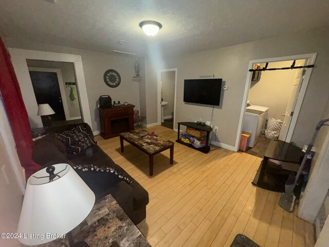 living room with hardwood / wood-style flooring and a textured ceiling