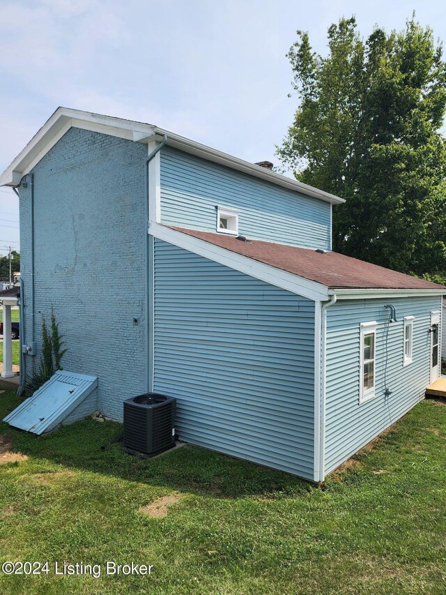 view of home's exterior featuring a lawn and central air condition unit