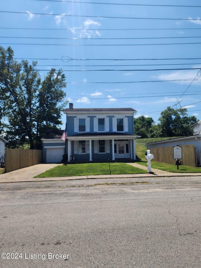 view of front of home with a front lawn and a garage