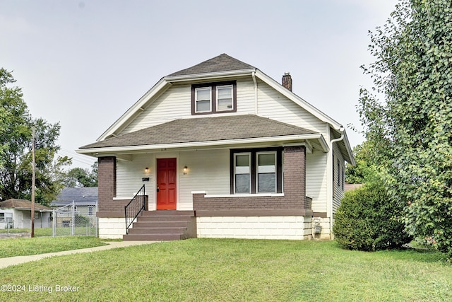 bungalow-style home with a front yard