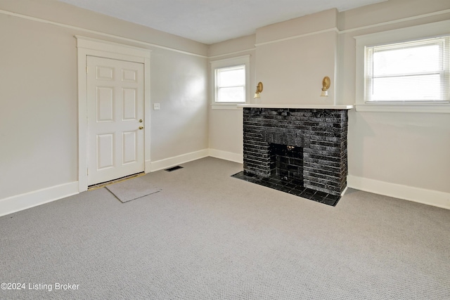 unfurnished living room featuring carpet and a fireplace