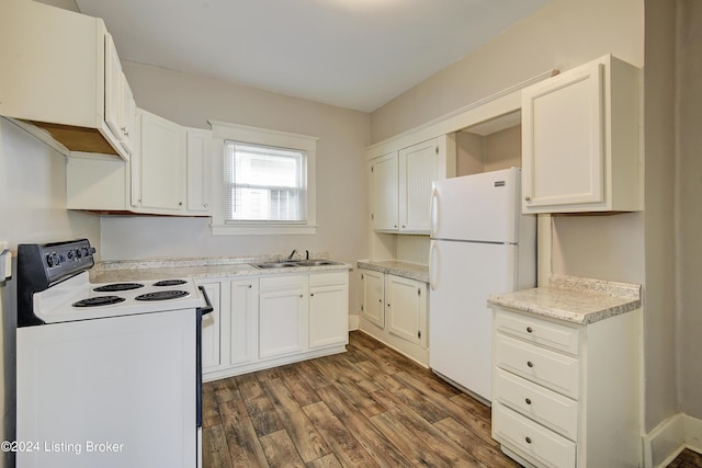 kitchen with white refrigerator, white cabinets, dark hardwood / wood-style flooring, and range with electric stovetop