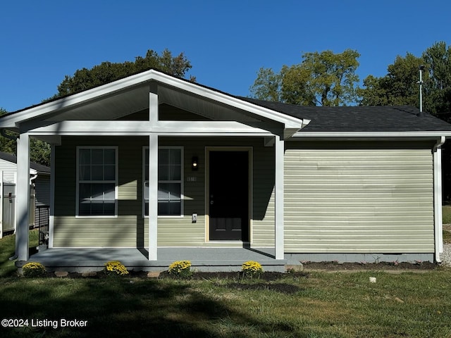 view of front of house featuring a front yard and a porch