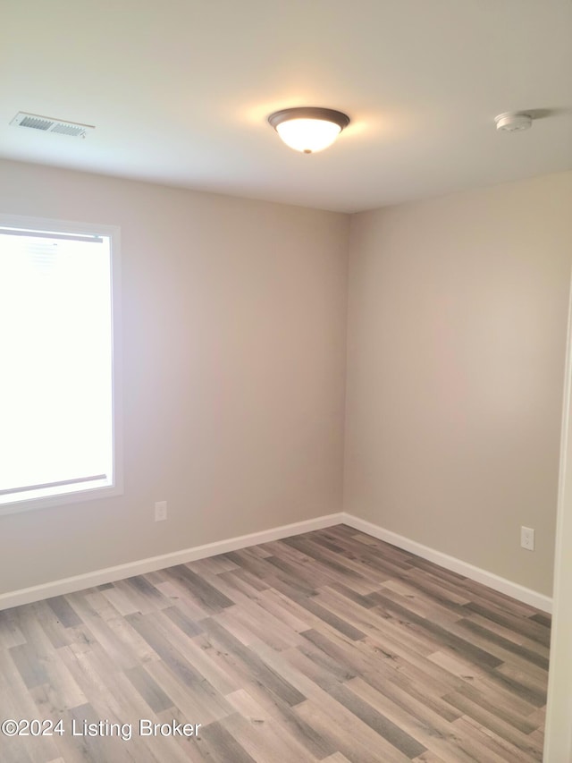 unfurnished room featuring hardwood / wood-style floors