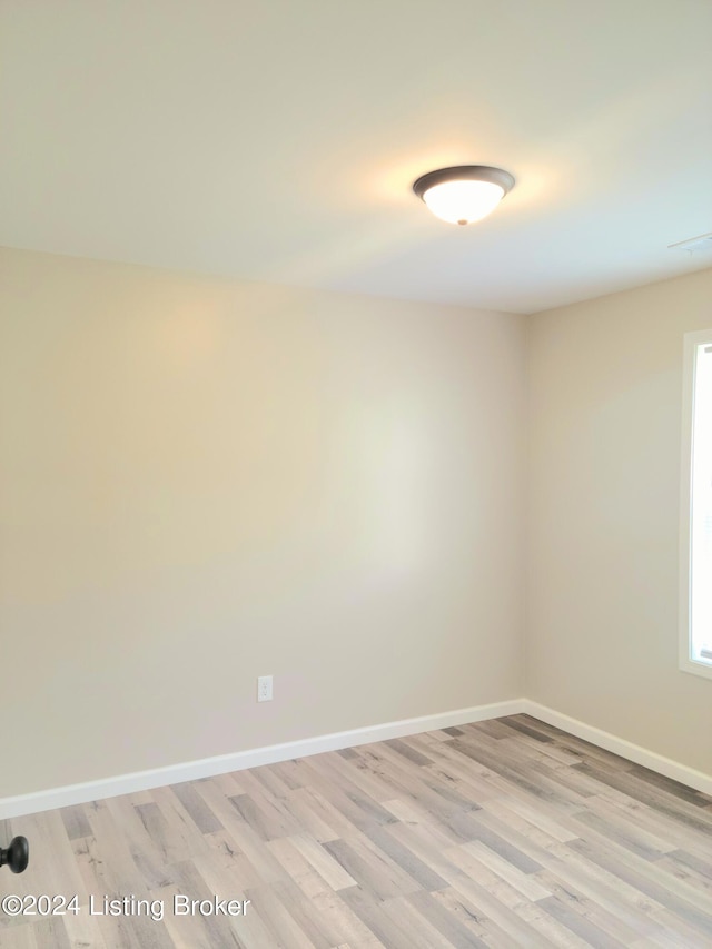 spare room with light hardwood / wood-style flooring