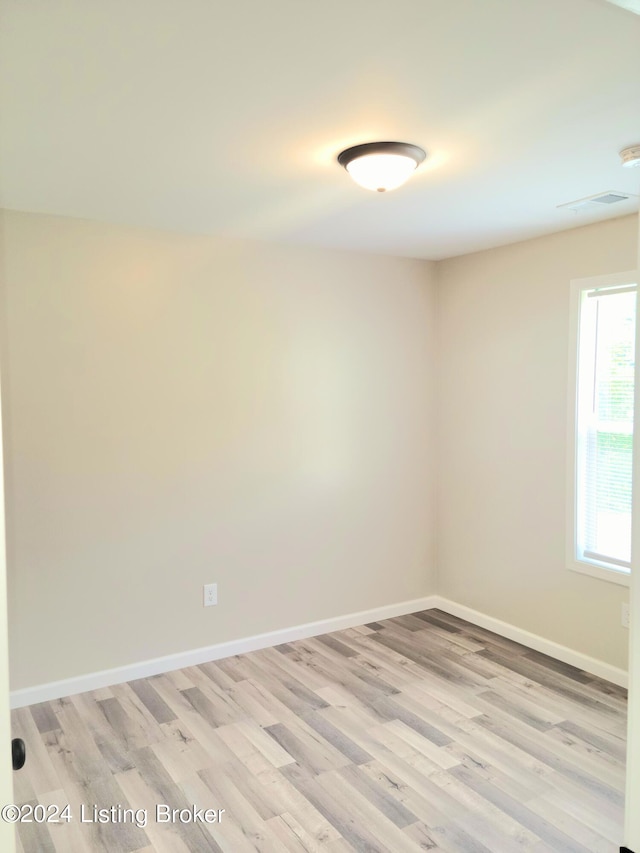 spare room with light hardwood / wood-style flooring