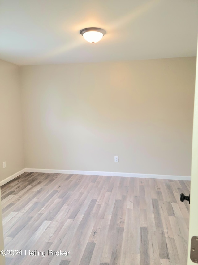 unfurnished room with light wood-type flooring