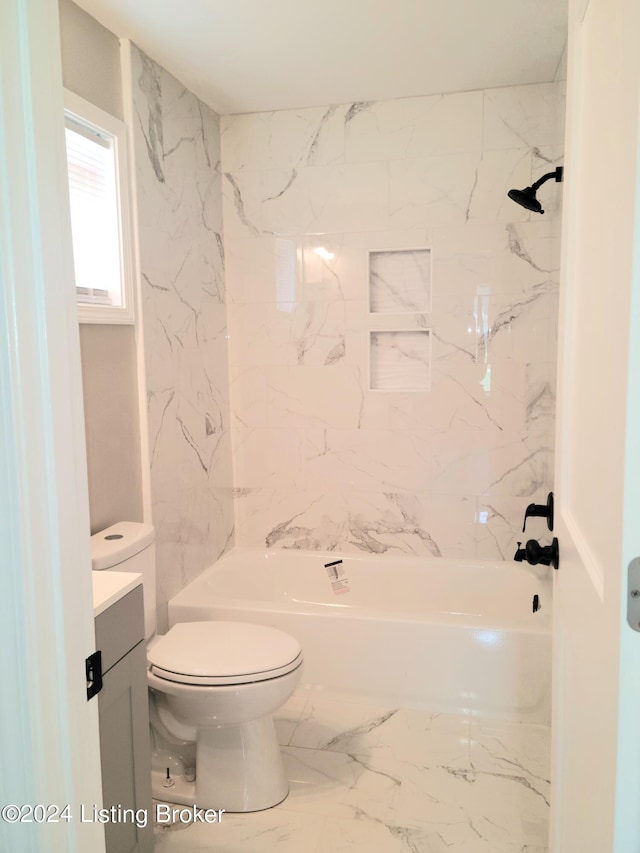 full bathroom featuring tiled shower / bath combo, vanity, and toilet