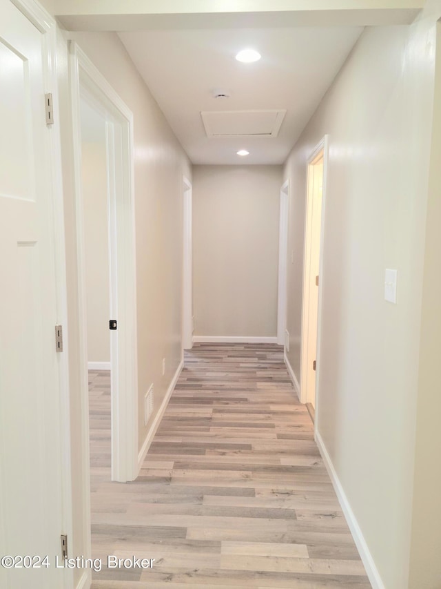 hall with light hardwood / wood-style flooring