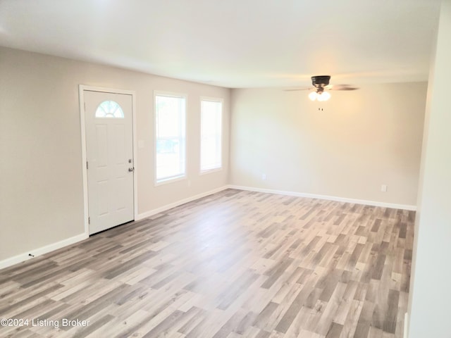 foyer entrance with ceiling fan and light hardwood / wood-style floors