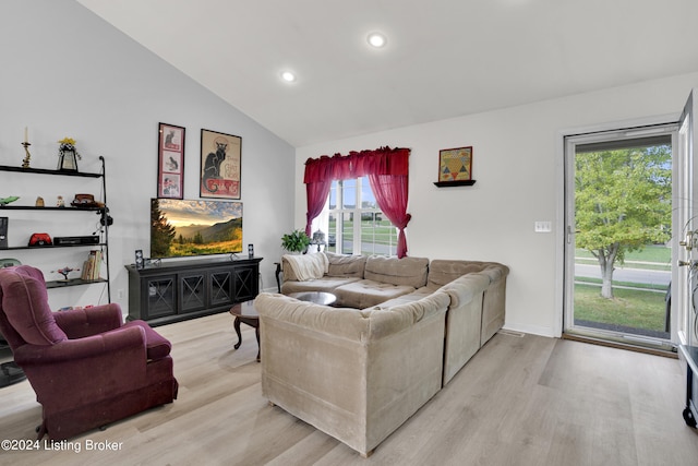 living room featuring lofted ceiling and light wood-type flooring