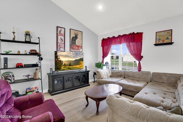 living room with light hardwood / wood-style flooring and lofted ceiling