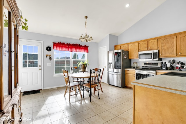 kitchen featuring a chandelier, appliances with stainless steel finishes, pendant lighting, and light tile patterned floors