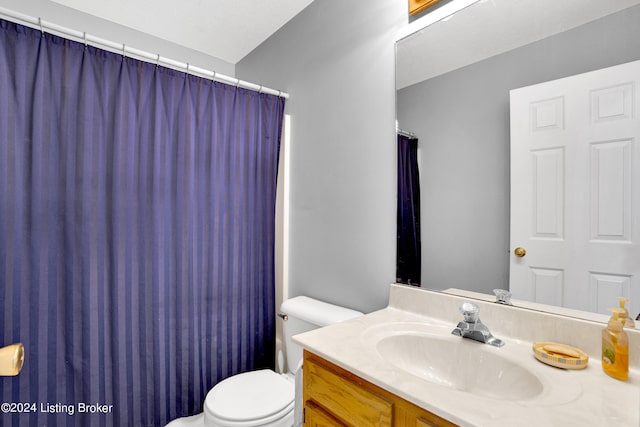 bathroom featuring toilet and vanity