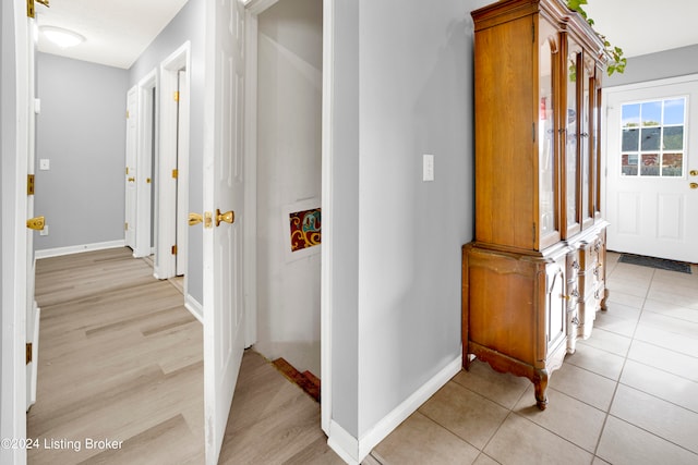 corridor featuring light tile patterned floors