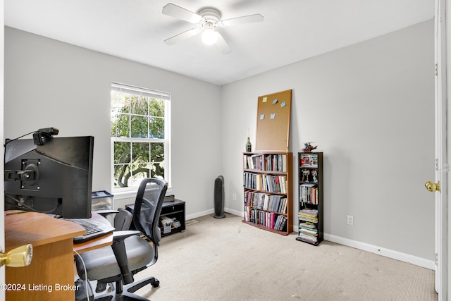 carpeted office featuring ceiling fan