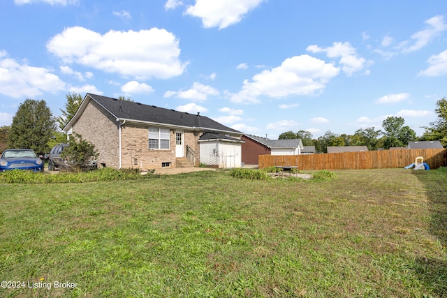 rear view of property with a lawn