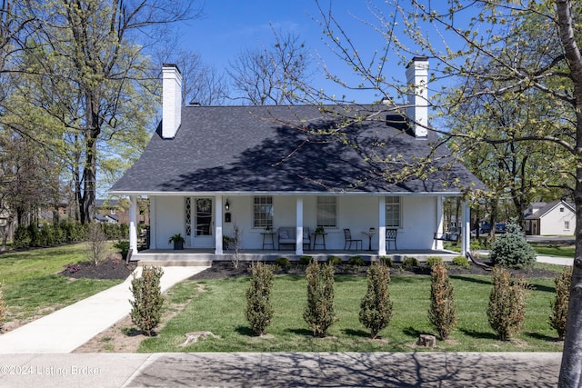 view of front of home with a porch and a front yard