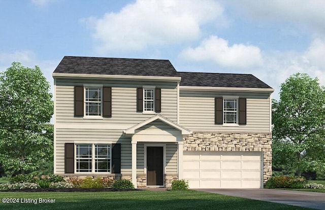 view of front of property with a garage and a front lawn