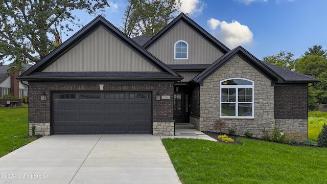 craftsman inspired home with a garage and a front lawn