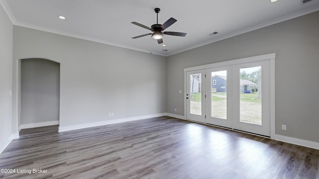 empty room featuring hardwood / wood-style flooring, crown molding, and ceiling fan