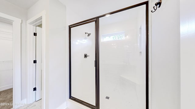 bathroom with a shower with door