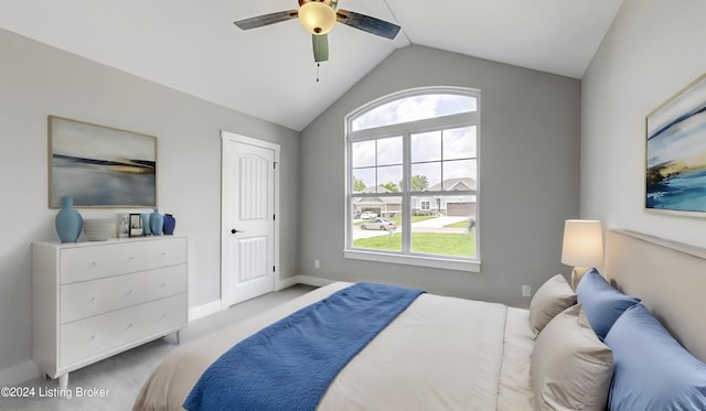 carpeted bedroom featuring multiple windows, lofted ceiling, and ceiling fan