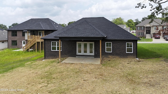 back of house featuring a patio and a lawn