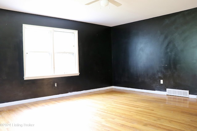 spare room with ceiling fan and wood-type flooring