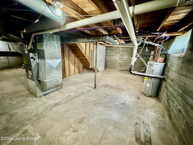 basement featuring heating unit and water heater