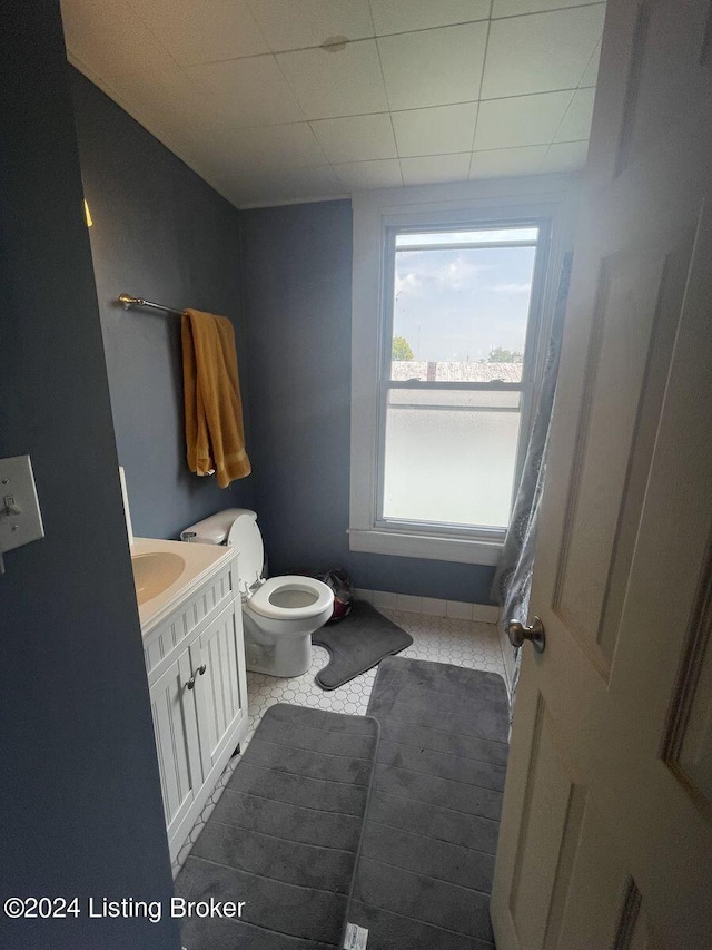 bathroom featuring vanity, tile patterned flooring, and toilet