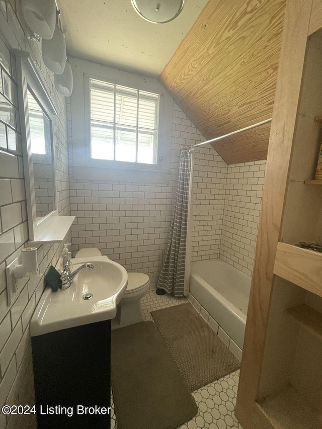 full bathroom featuring lofted ceiling, toilet, shower / tub combo with curtain, tile walls, and tile patterned floors