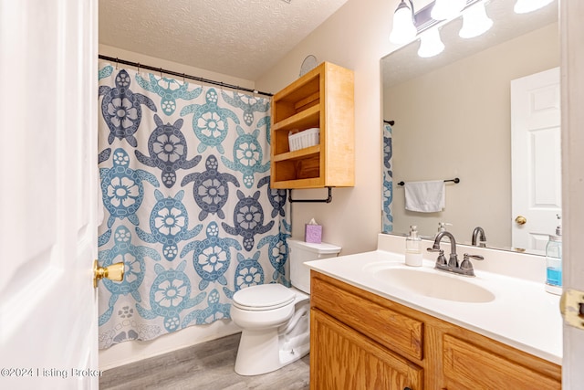 bathroom with vanity, a textured ceiling, toilet, and hardwood / wood-style flooring