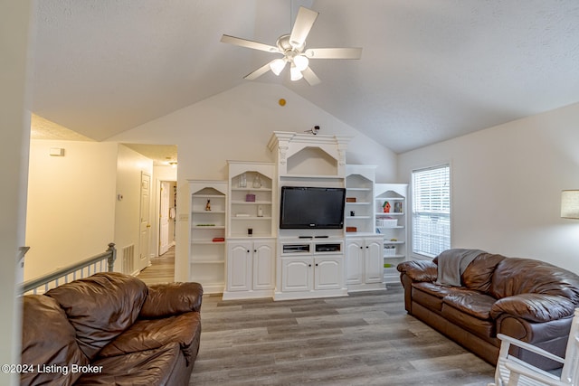 living room with ceiling fan, lofted ceiling, and hardwood / wood-style floors